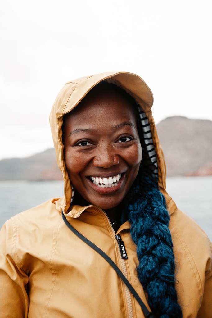 Smiling Mind the Seas guest wearing a yellow jacket on an expedition in La Paz