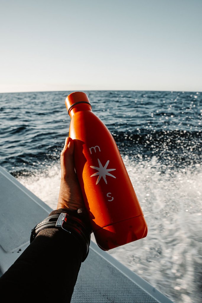 Orange Mind the Seas bottle aboard a boat in Magdalena Bay